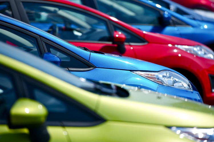 green, blue, and red cars lined up