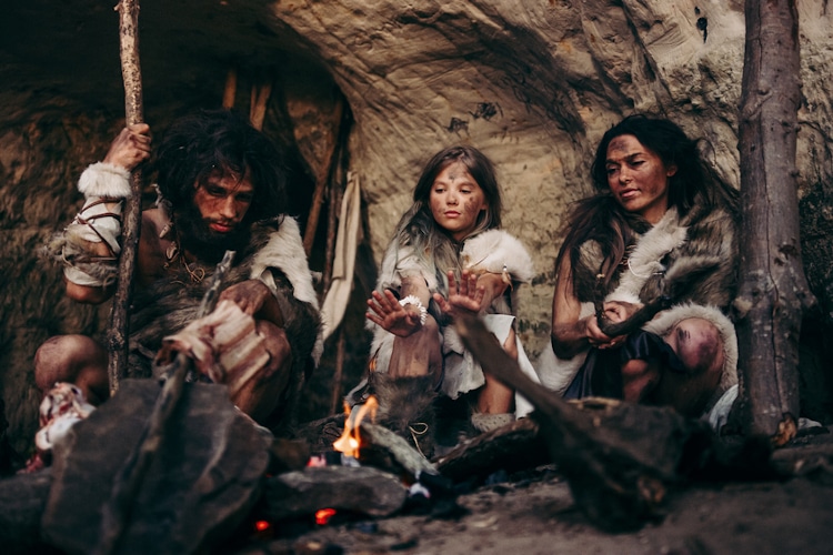 Tribe of Prehistoric PrimitiveHunter-Gatherers Live in a Cave at Night. 